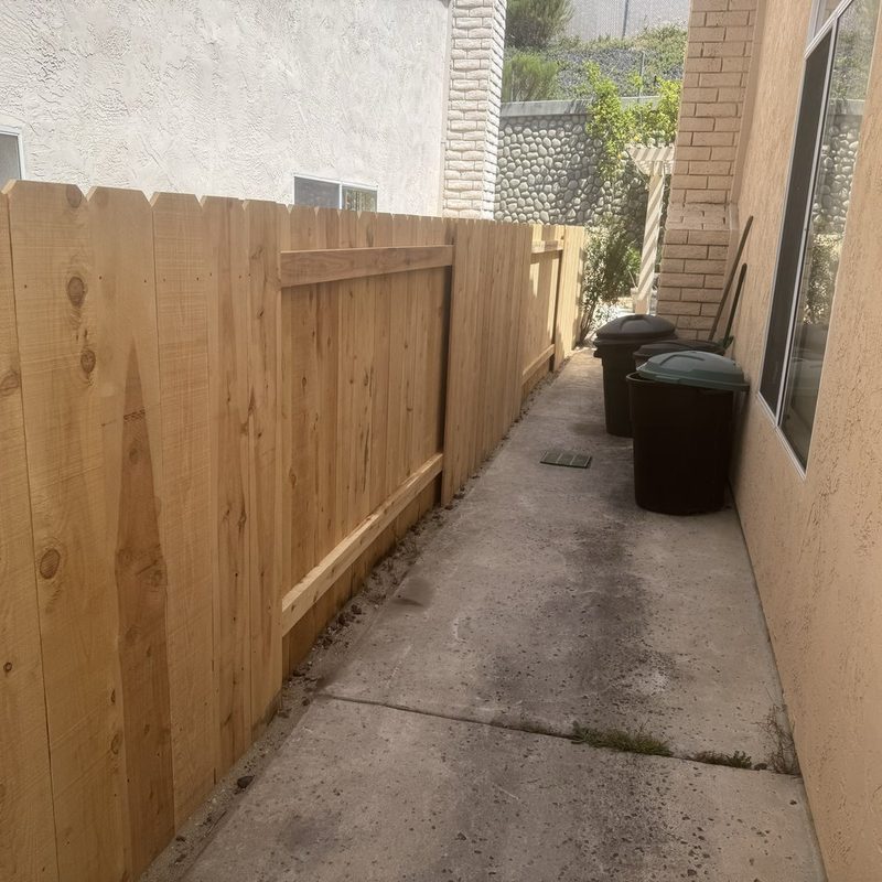 Cedar good neighbor fence running along a side yard walkway