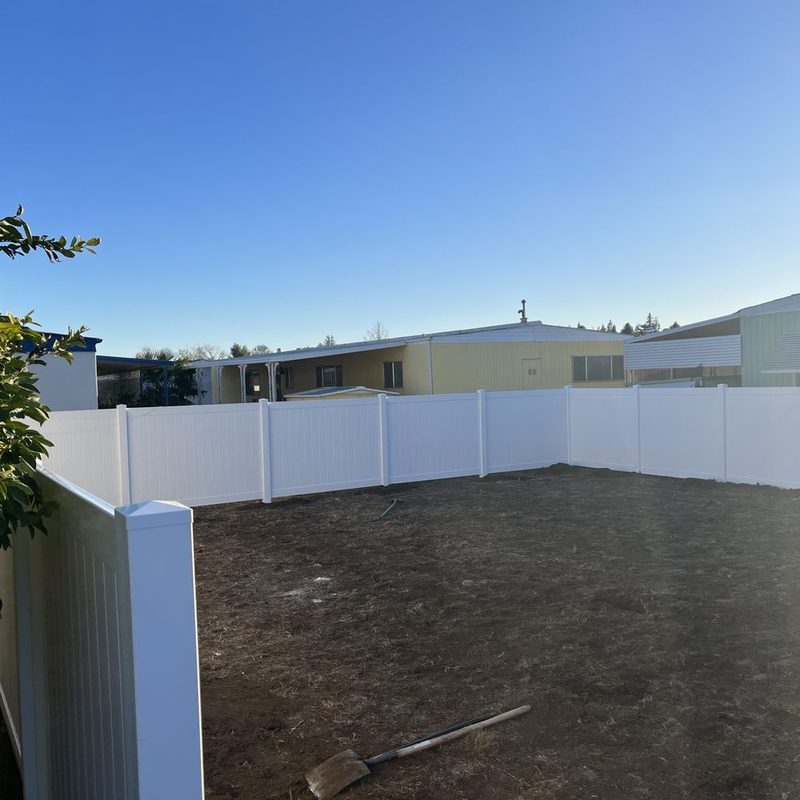 White vinyl privacy fence forming a clean back property line