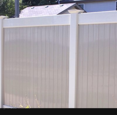 Two-tone white and sandstone vinyl privacy fence panel detail